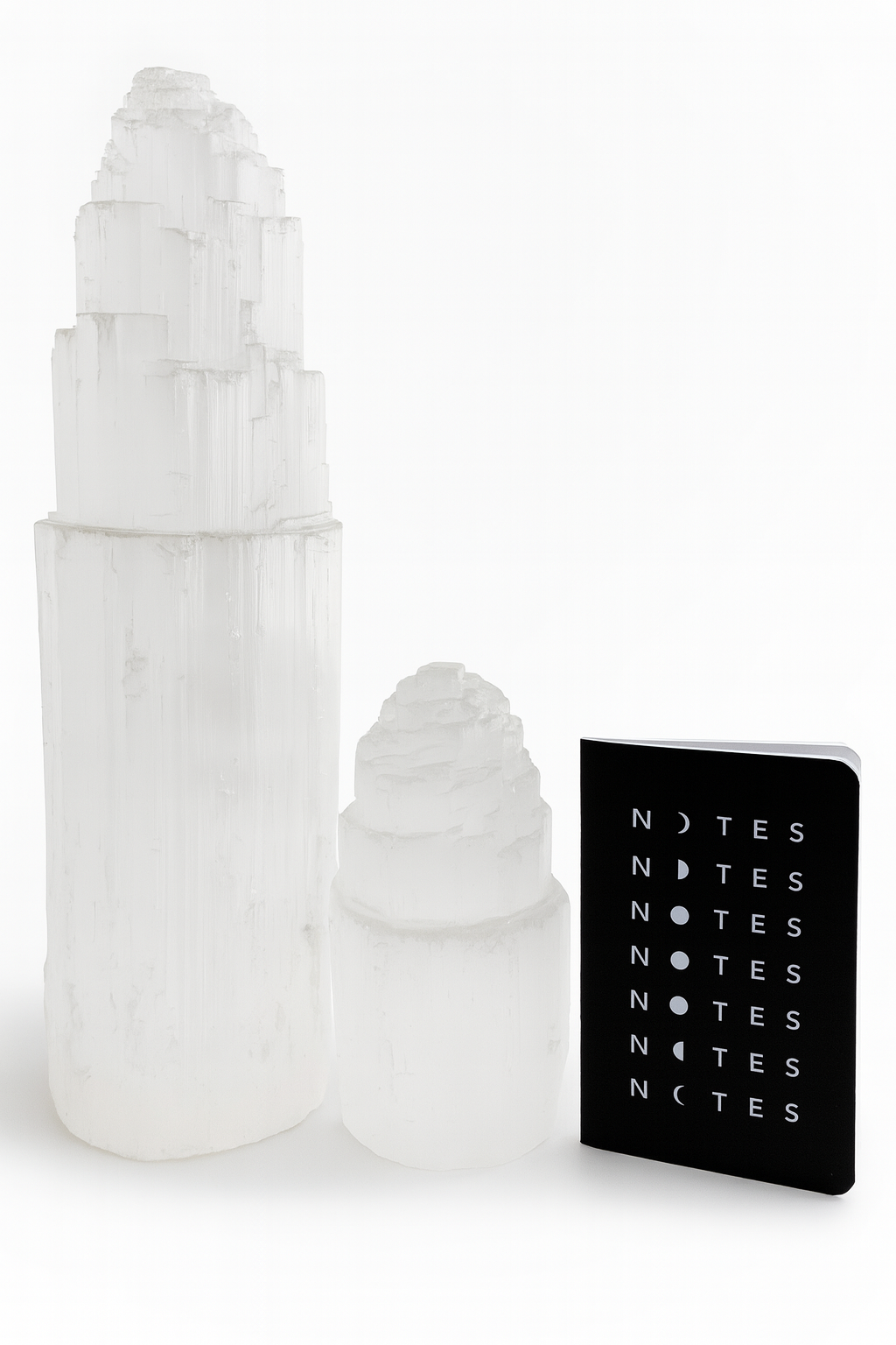 Decorative white ice cream cone-shaped objects with a black notebook labeled 'NOTES' on a white background