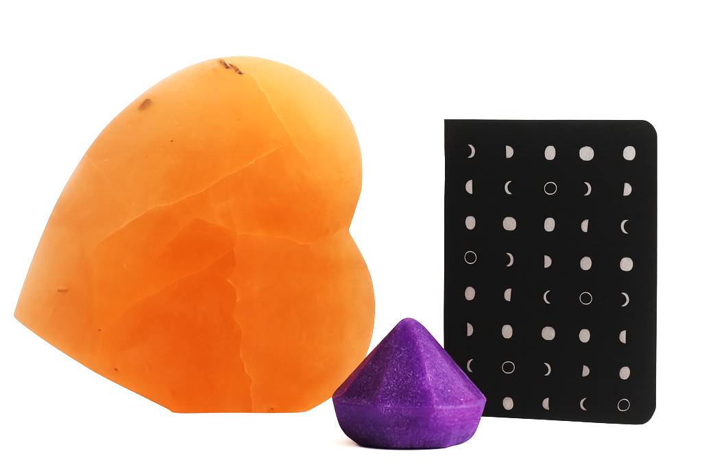 Orange and purple silicone sponges with a black earring display on a white background