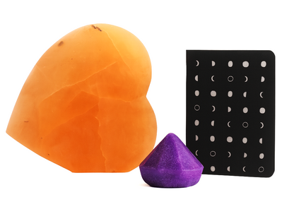 Orange and purple silicone sponges with a black earring display on a white background